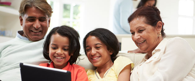 image of family viewing laptop with children