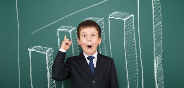 image of student in front of chalkboard bar graph